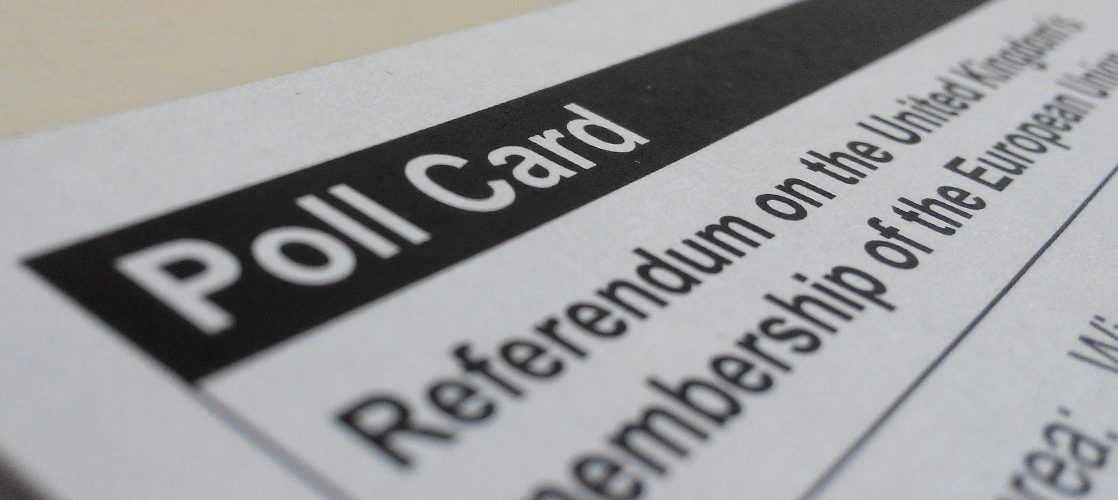 [IMAGE] Close up of a polling card for the UK referendum on leaving the EU. In the foreground, it reads "Poll Card" in white letters on a black background.