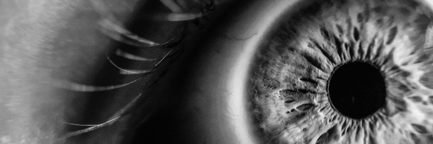 [IMAGE] A close up of an open eye in black and white.
