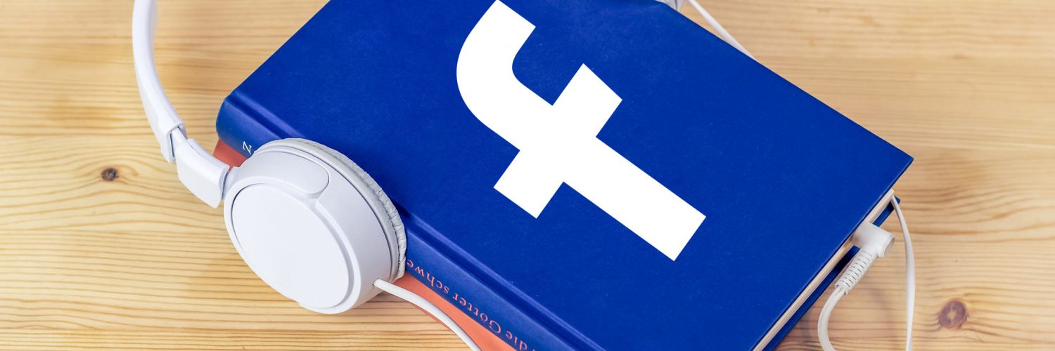 [IMAGE] A book with the Facebook logo on it and a pair of headphones wrapped around the book