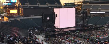 The Opening of a Concert with a large screen facing a filling stadium