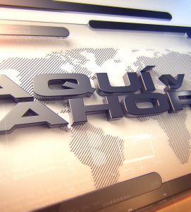 [IMAGE] A large TV graphic that says Aqui y Ahora in 3D letters. In the background of the graphic is a map of the world.