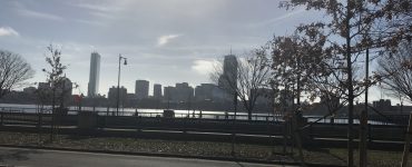 [IMAGE] Morning on the Charles River looking towards Boston from Cambridge. A road is in the foreground, the Boston skyline in the background. There are no cars or people.