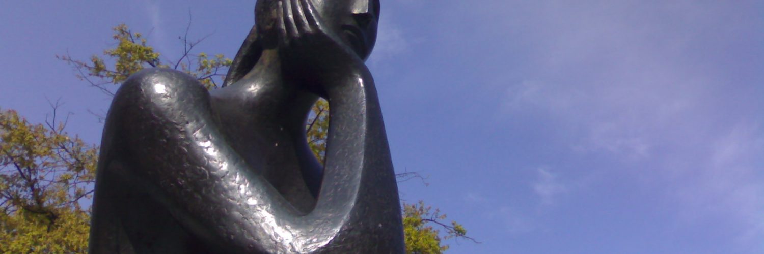 La Pensadora an impressionistic statue by Jose Louis Fernandez in metal of a woman thinking
